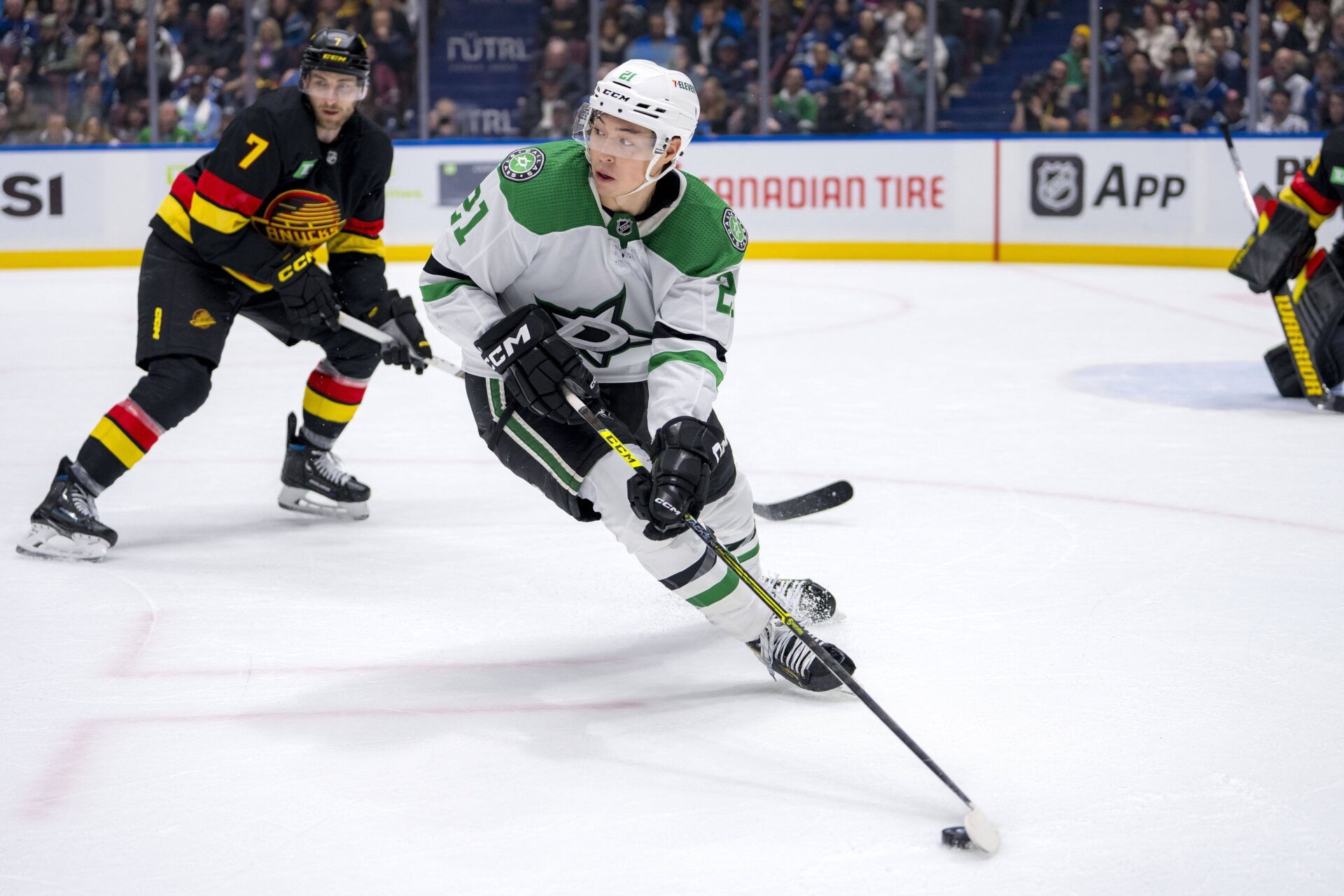 Dallas Stars forward Jason Robertson (21) handles the puck against the Vancouver Canucks in the second period at Rogers Arena.