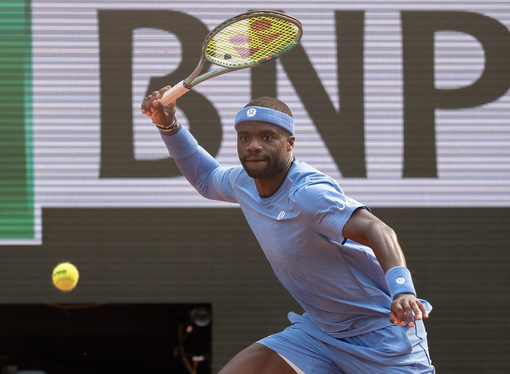 Frances Tiafoe of the United States returns a shot during his match  against Lorenzo Musetti of Italy on day 10 at Roland Garros Stadium.