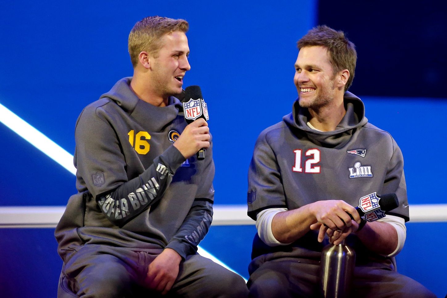 Los Angeles Rams quarterback Jared Goff (16) and New England Patriots quarterback Tom Brady (12) during Opening Night for Super Bowl LIII at State Farm Arena.