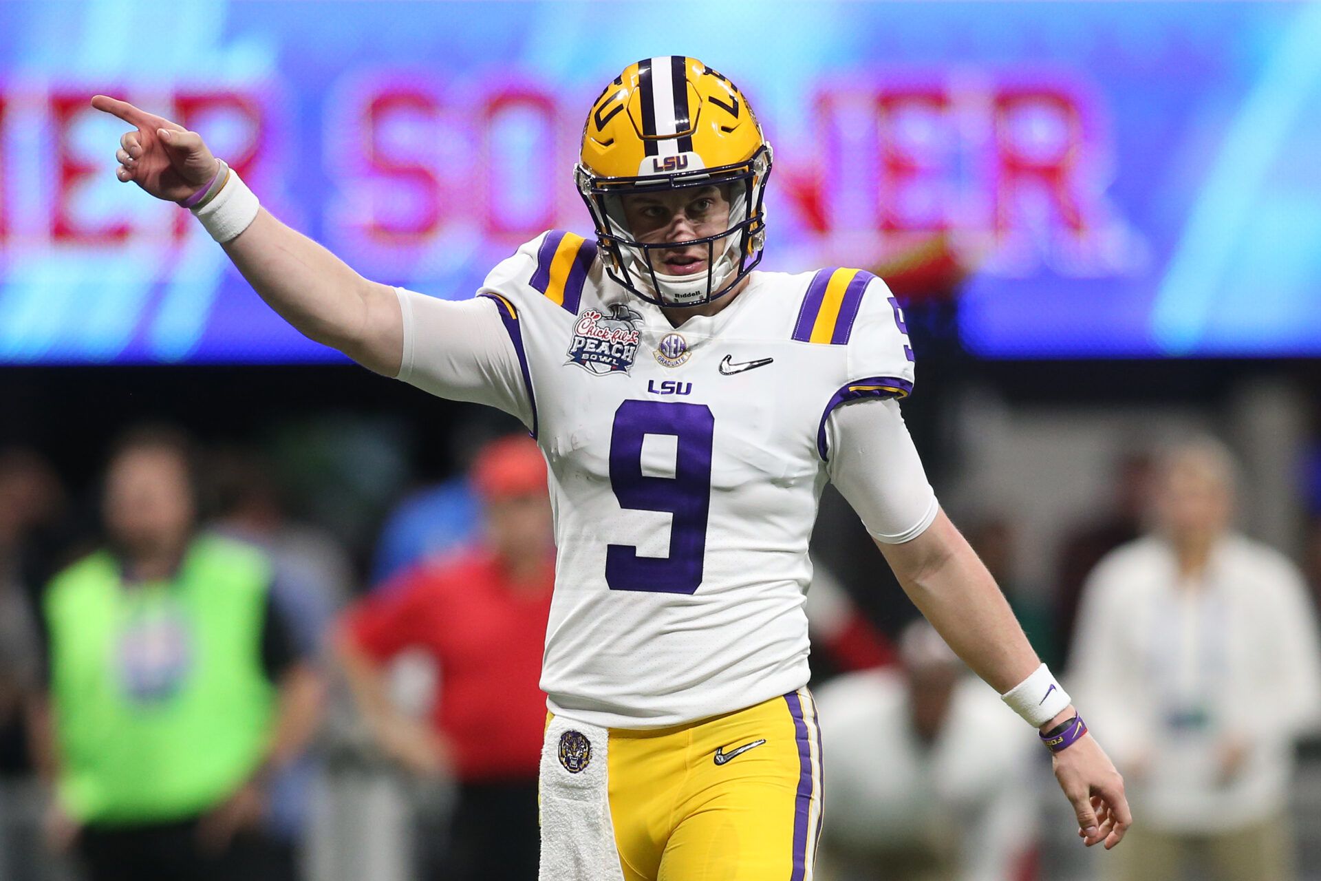 LSU Tigers quarterback Joe Burrow (9) signals during the third quarter of the 2019 Peach Bowl college football playoff semifinal game against the Oklahoma Sooners.
