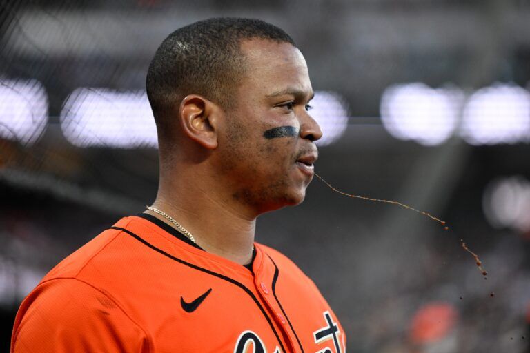 San Francisco Giants designated hitter Rafael Devers (16) spits while in the dugout against the Boston Red Sox in the fourth inning at Oracle Park.
