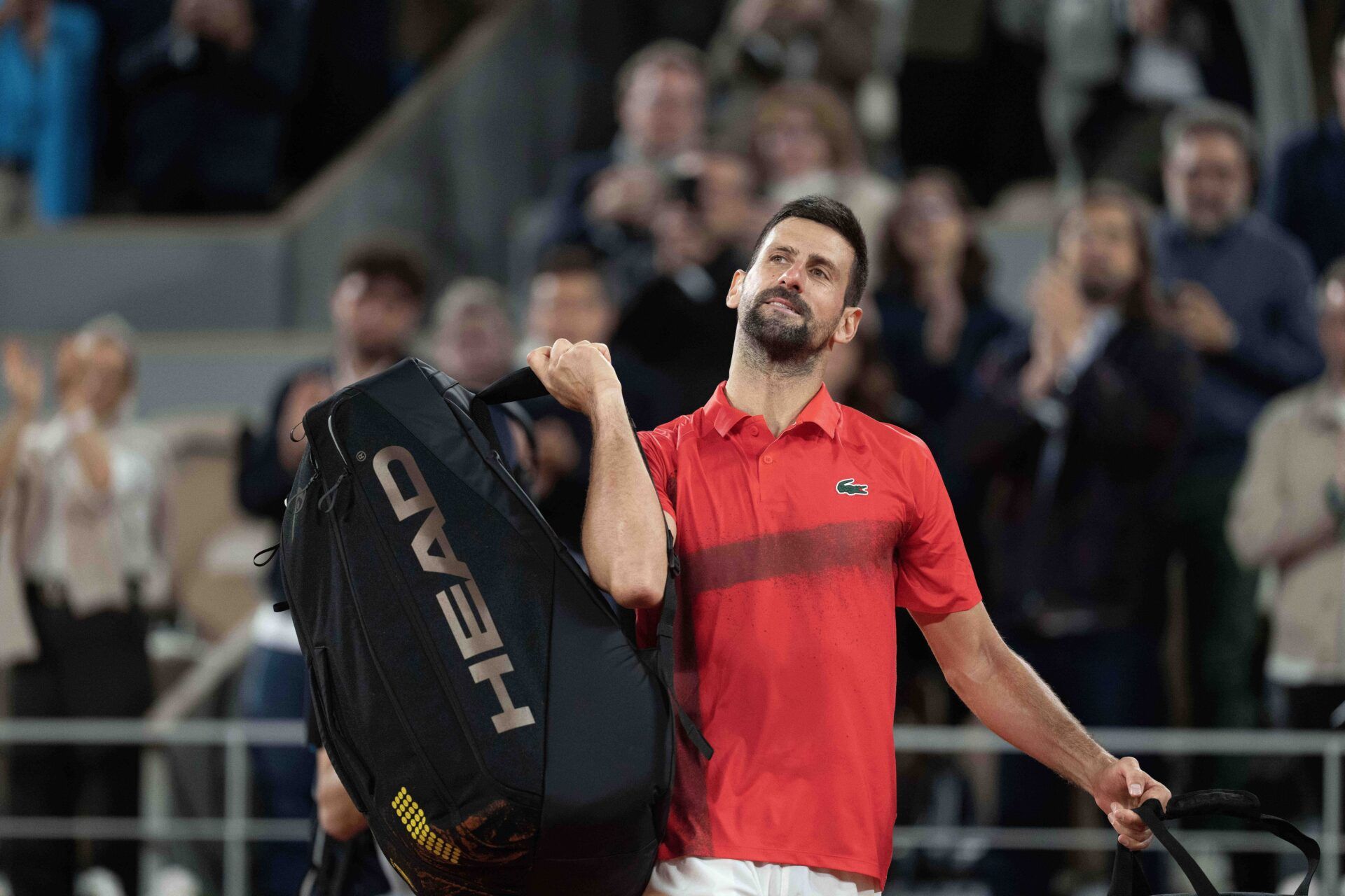 Novak Djokovic of Serbia says goodbye to the spectators and the clay after losing his match against Jannik Sinner of Italy on day 13 at Roland Garros Stadium.