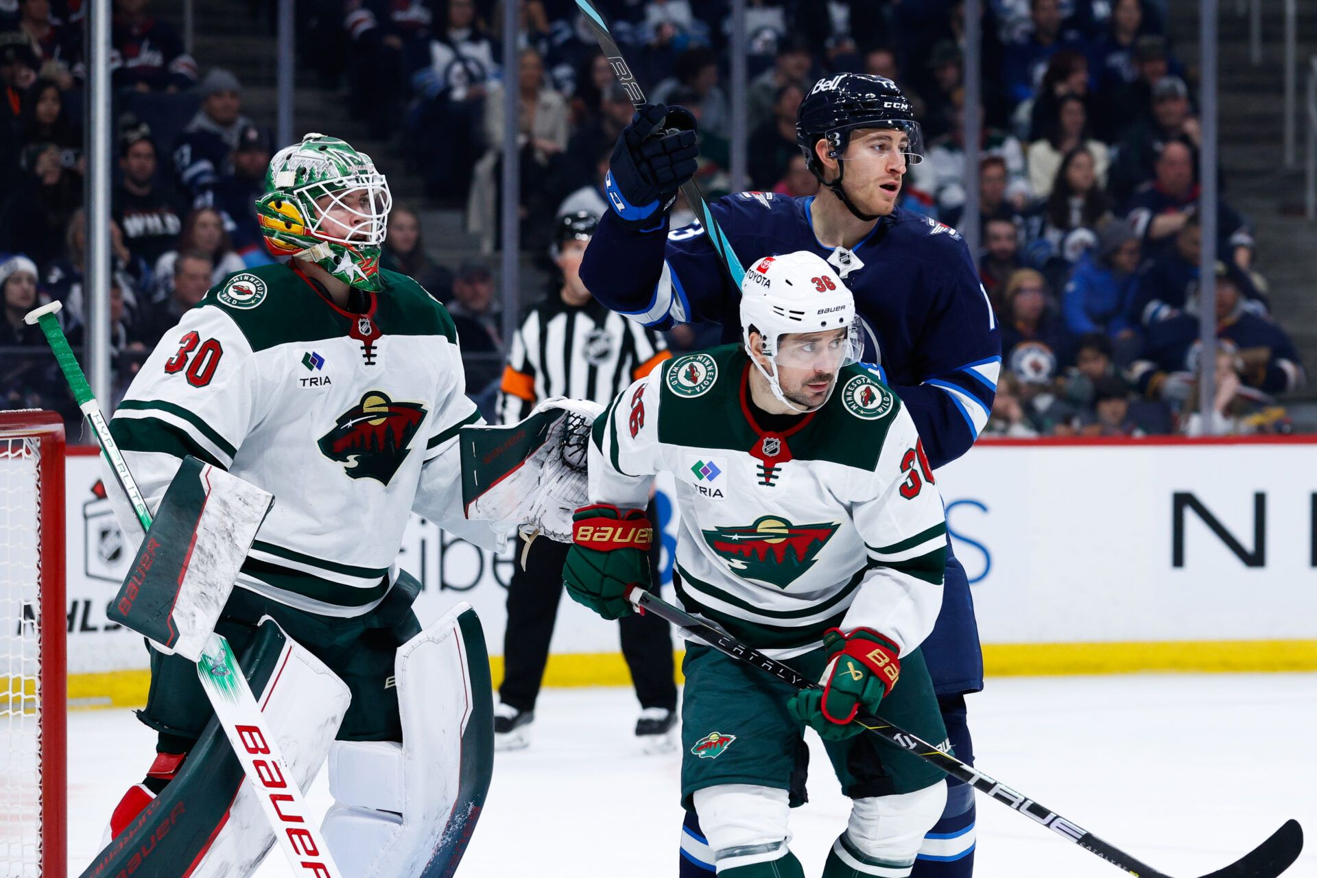 Minnesota Wild goalie Jesper Wallstedt (30), Minnesota Wild forward Mats Zuccarello (36) and Winnipeg Jets forward Gabriel Vilardi (13) look for the puck during the second period at Canada Life Centre.