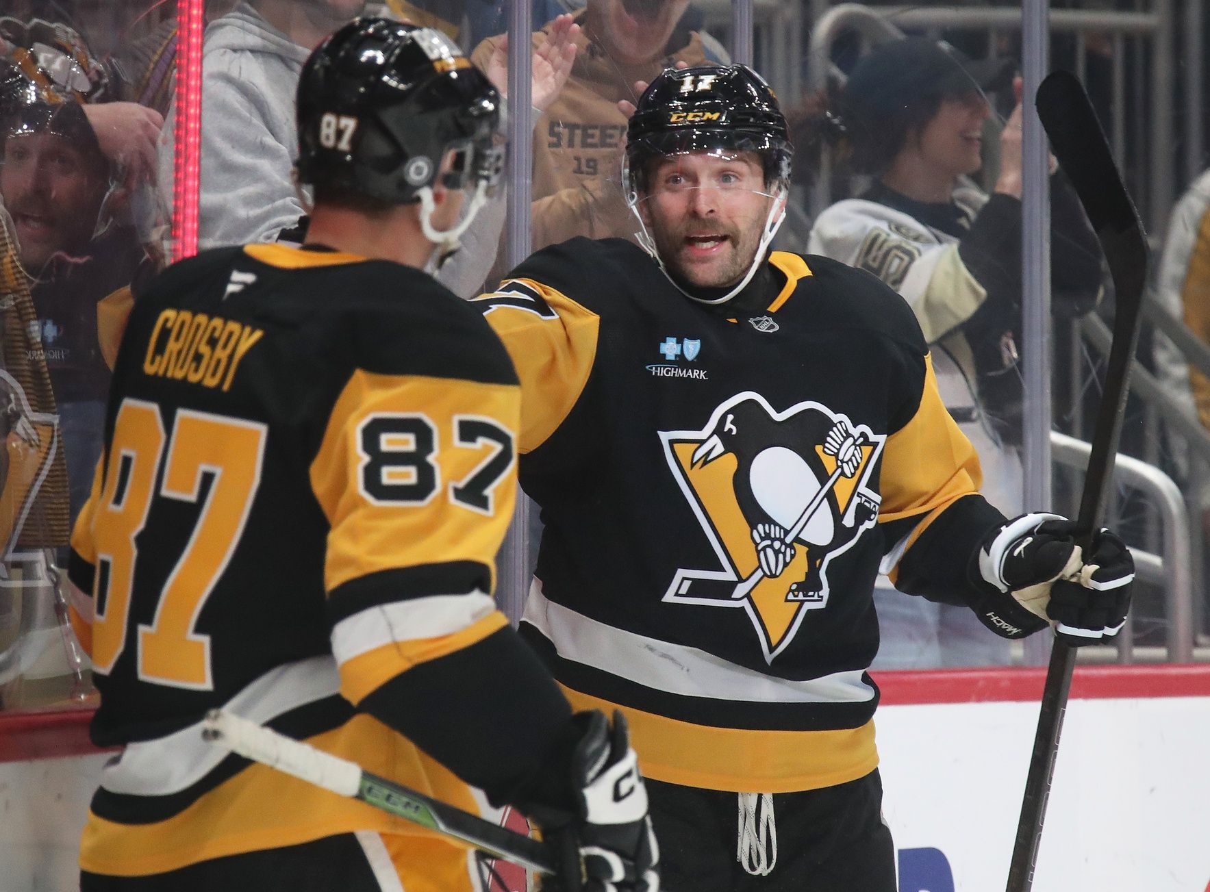 Pittsburgh Penguins right wing Bryan Rust (17) celebrates his goal with center Sidney Crosby (87) against the Vancouver Canucks during the first period at PPG Paints Arena.