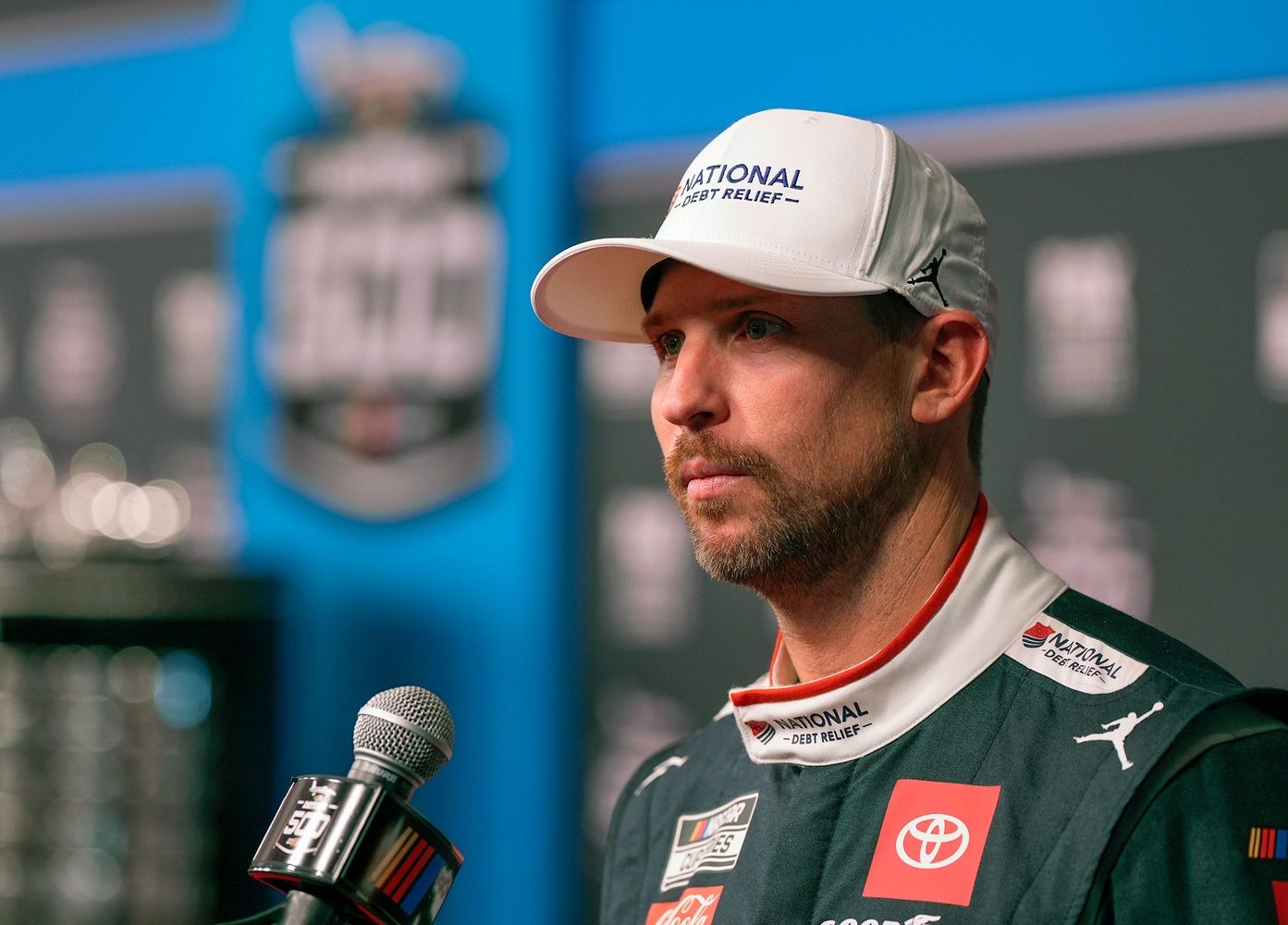 Denny Hamlin answers questions from reporters during Media Day at Daytona International Speedway, Wednesday, Feb. 12, 2025.