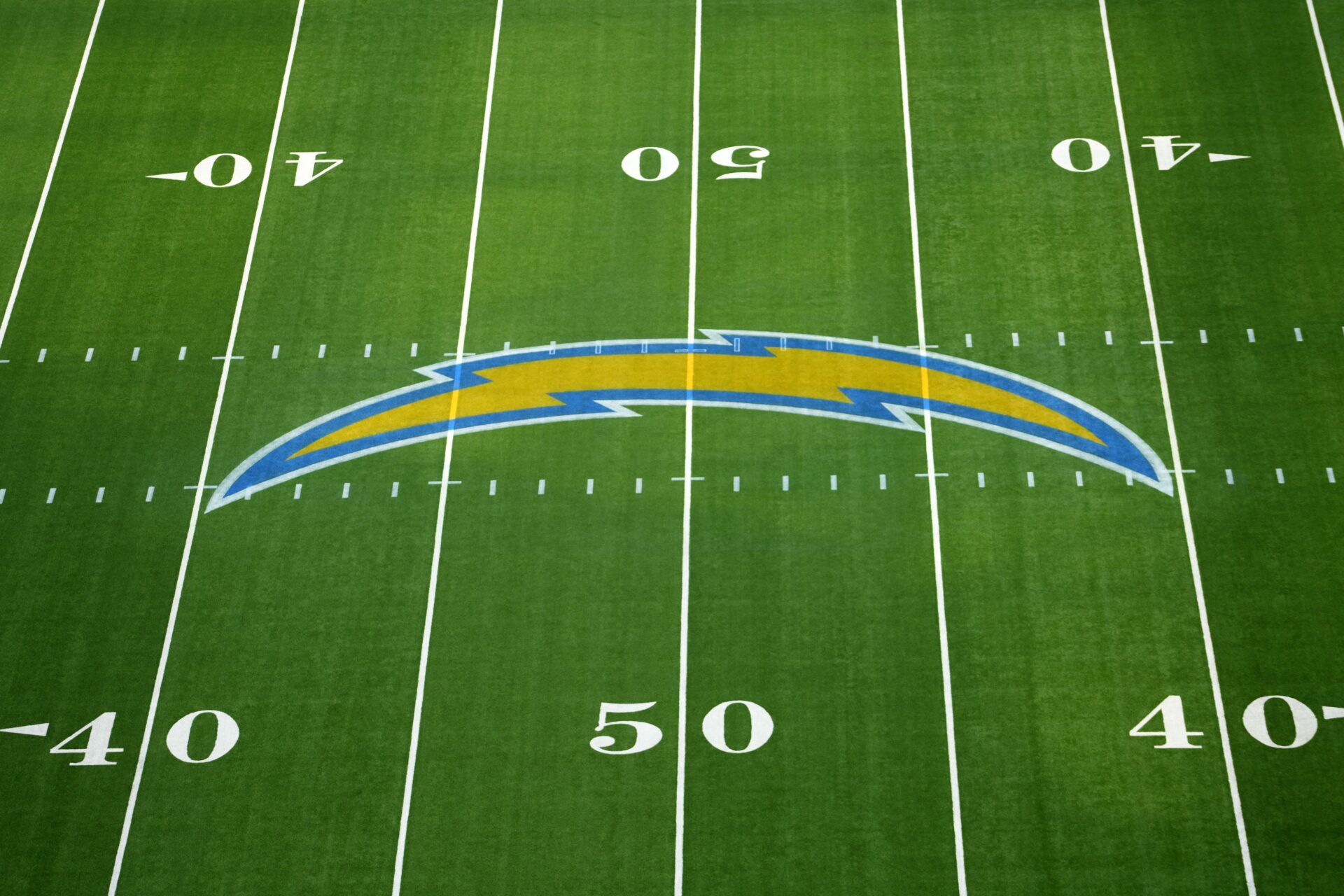 The Los Angeles Chargers bolt logo at midfield at SoFi Stadium.