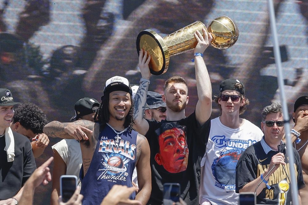 Oklahoma City Thunder center Isaiah Hartenstein holds the Larry O'Brien Championship Trophy during the Oklahoma City Thunder Champions parade.