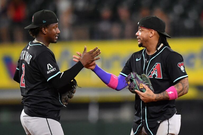 Arizona Diamondbacks shortstop Geraldo Perdomo (left) and second baseman Ketel Marte (right) celebrate after defeating the Chicago White Sox at Rate Field.
