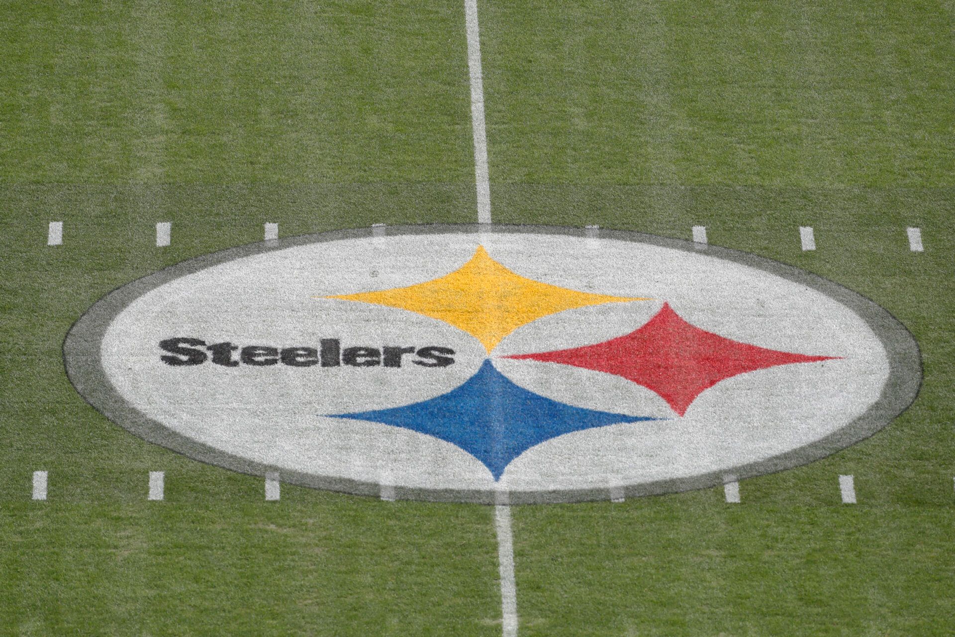 General view of the 50 yard line and team logo before the Pittsburgh Steelers host the New England Patriots at Acrisure Stadium.