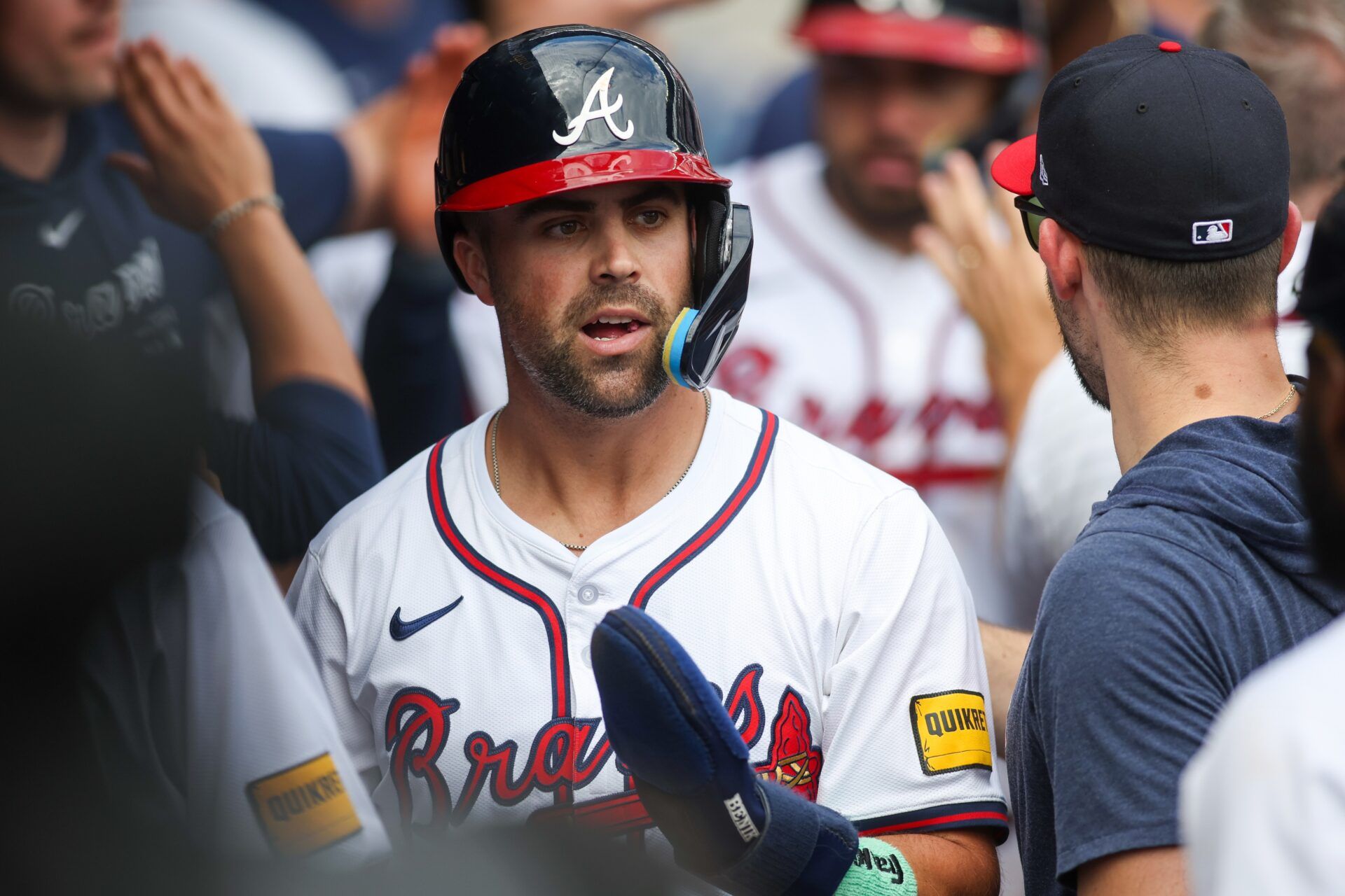 Atlanta Braves left fielder Whit Merrifield (15) celebrates with teammates after scoring a run against the New York Mets in the eighth inning at Truist Park.