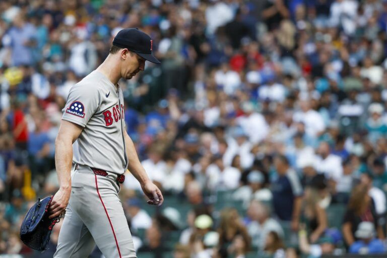 Boston Red Sox starting pitcher Walker Buehler (0) walks to the dugout after being relieved for during the fourth inning against the Seattle Mariners at T-Mobile Park.