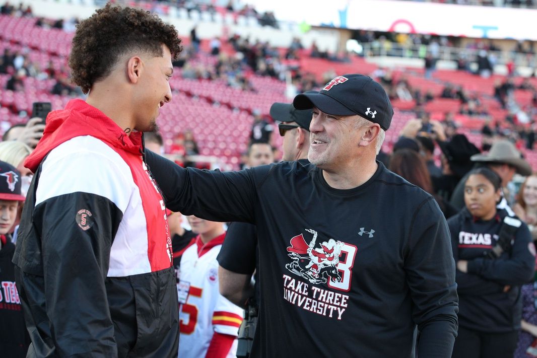 Kansas City Chiefs quarterback Patrick Mahomes talks with Texas Tech Red Raiders head coach Joey McGuire before the game against the Baylor Bears at Jones AT&T Stadium and Cody Campbell Field.