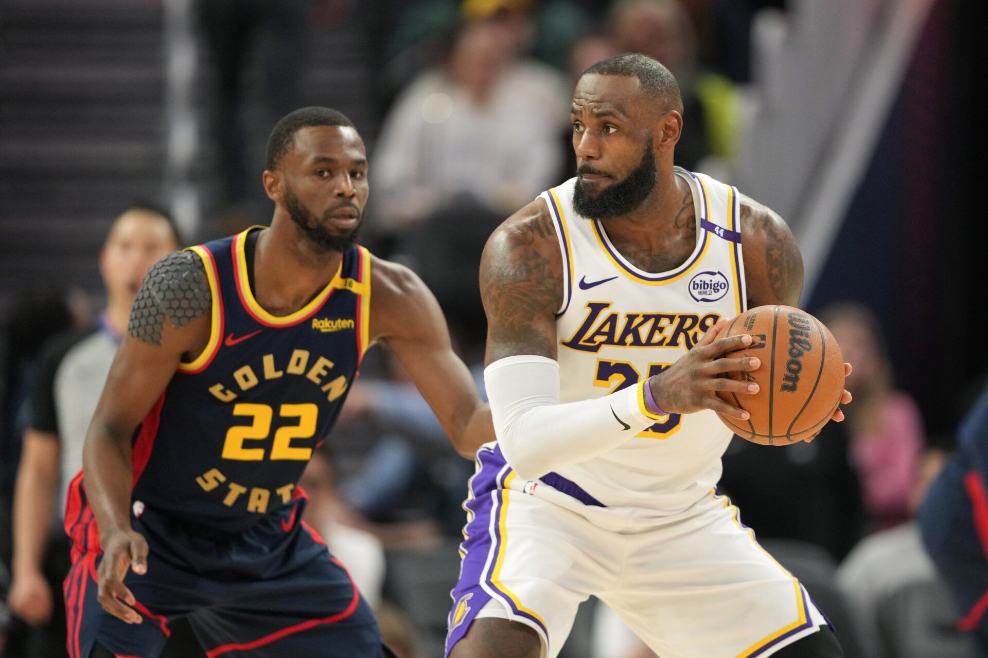 Los Angeles Lakers forward LeBron James (right) handles the ball against Golden State Warriors forward Andrew Wiggins (22) during the third quarter at Chase Center.