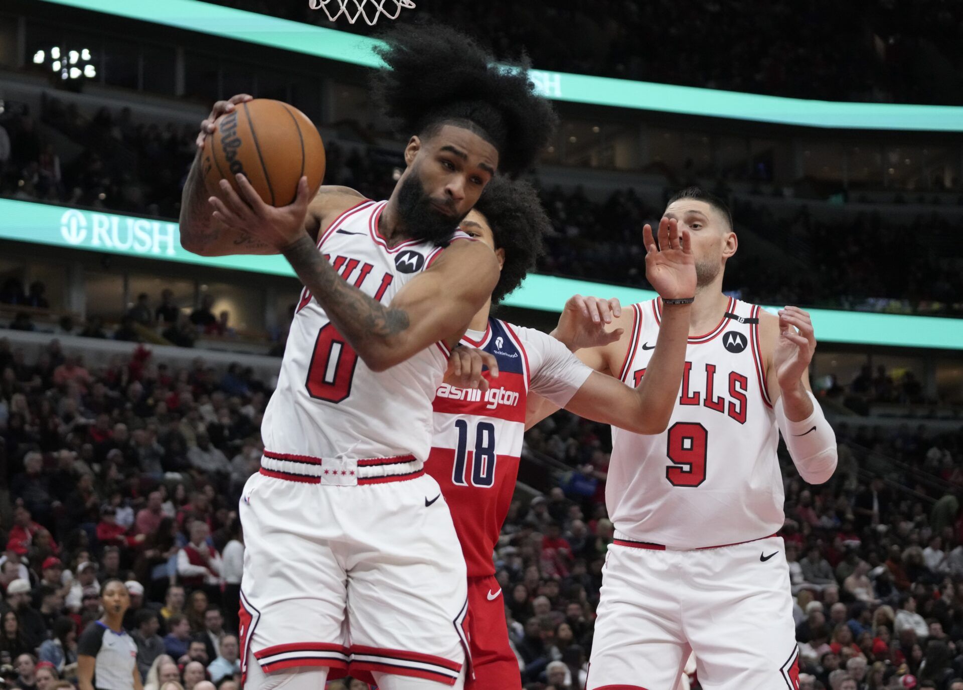 Washington Wizards forward Kyshawn George (18) defends Chicago Bulls guard Coby White (0) during the second half at United Center.