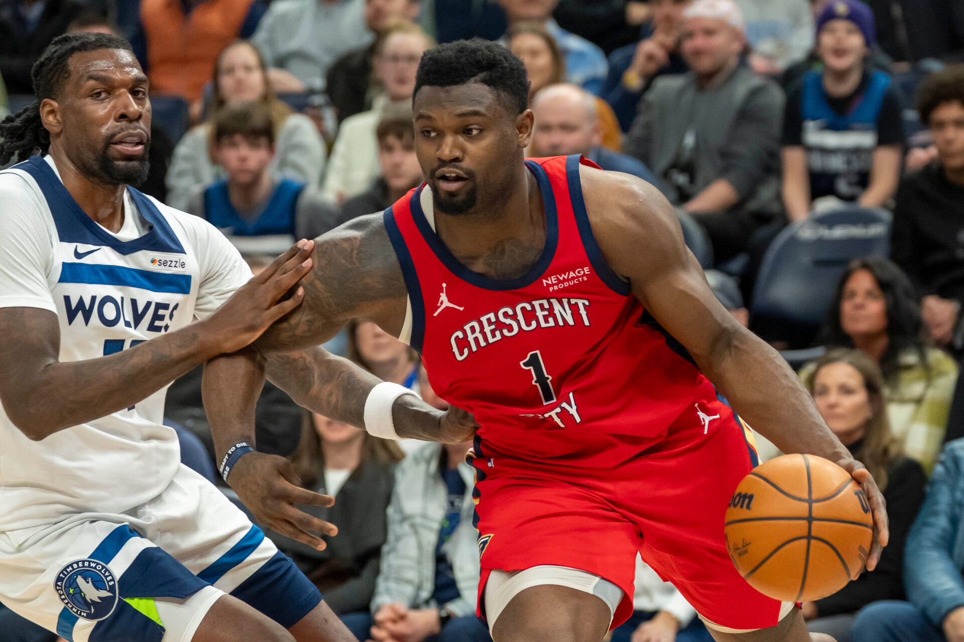 New Orleans Pelicans forward Zion Williamson (1) drives to the basket past Minnesota Timberwolves center Naz Reid (11) in the second half at Target Center.