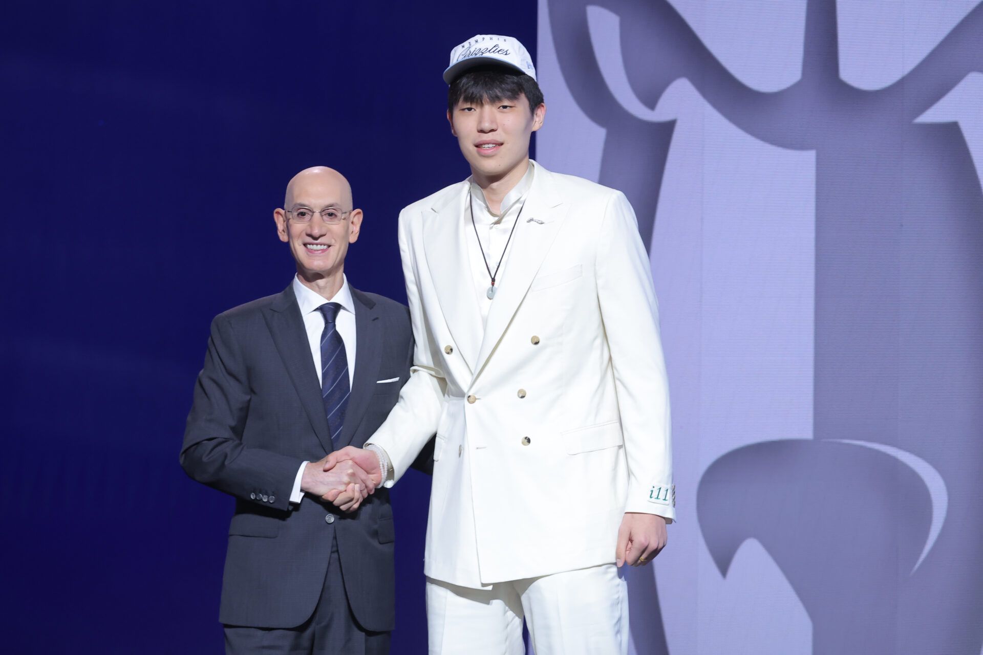 Yang Hansen stands with NBA commissioner Adam Silver after being selected as the 16th pick by the Memphis Grizzlies in the first round of the 2025 NBA Draft at Barclays Center.