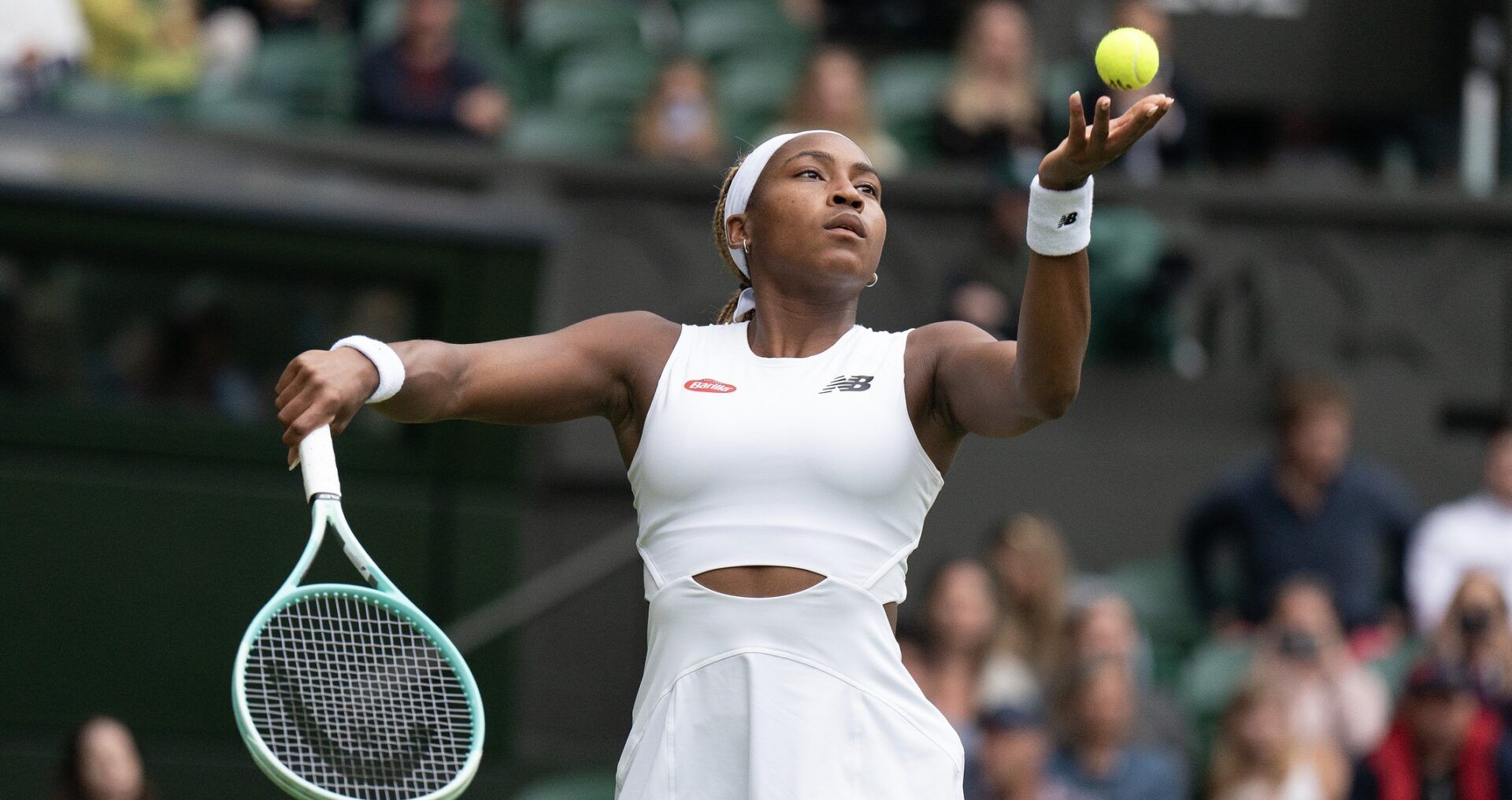 Coco Gauff of the United States tosses the ball to serve during her match against Caroline Dolehide of the United States (not shown) on day one of The Championships at All England Lawn Tennis and Croquet Club.