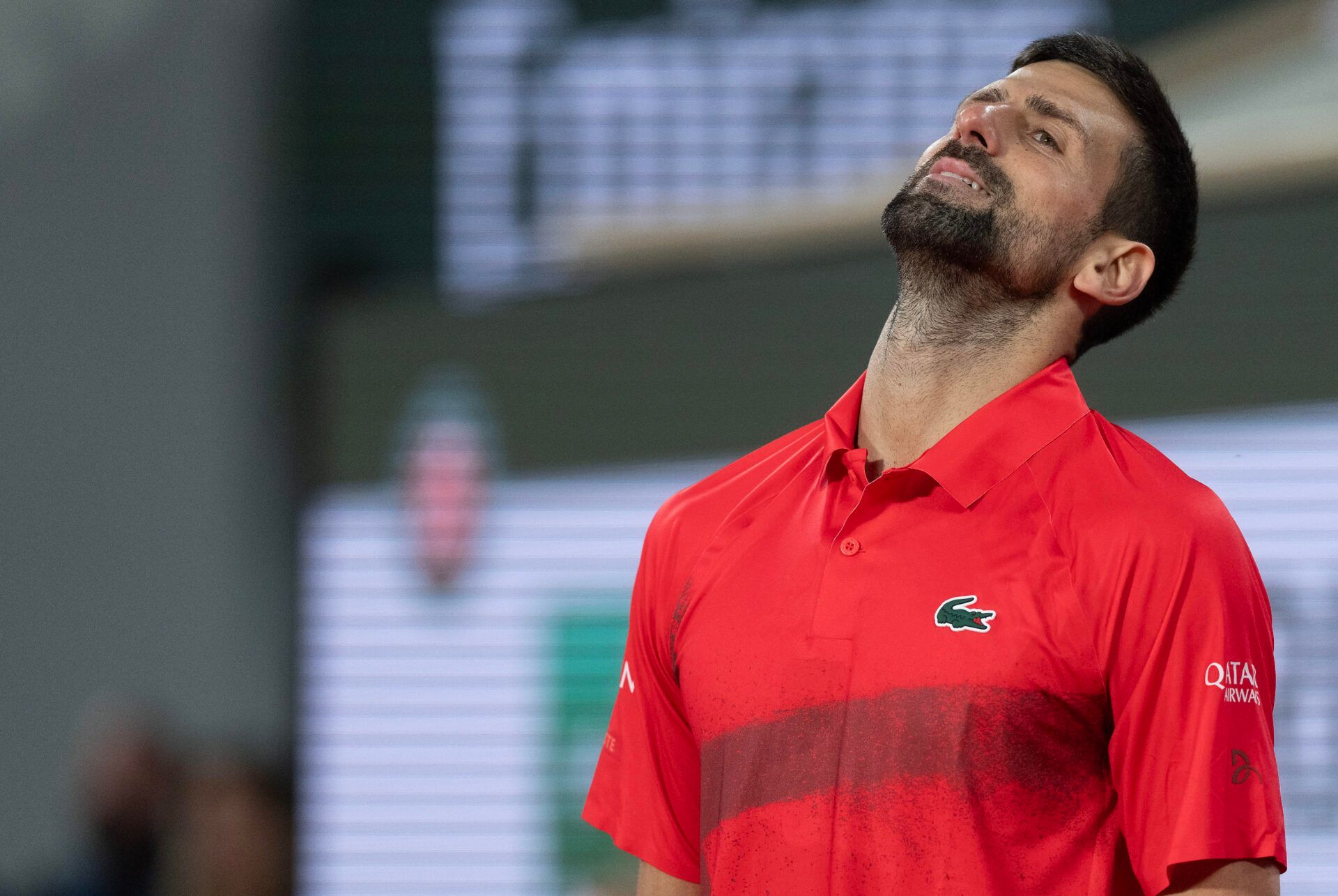 Novak Djokovic of Serbia reacts to a point during his match against Jannik Sinner of Italy on day 13 at Roland Garros Stadium.