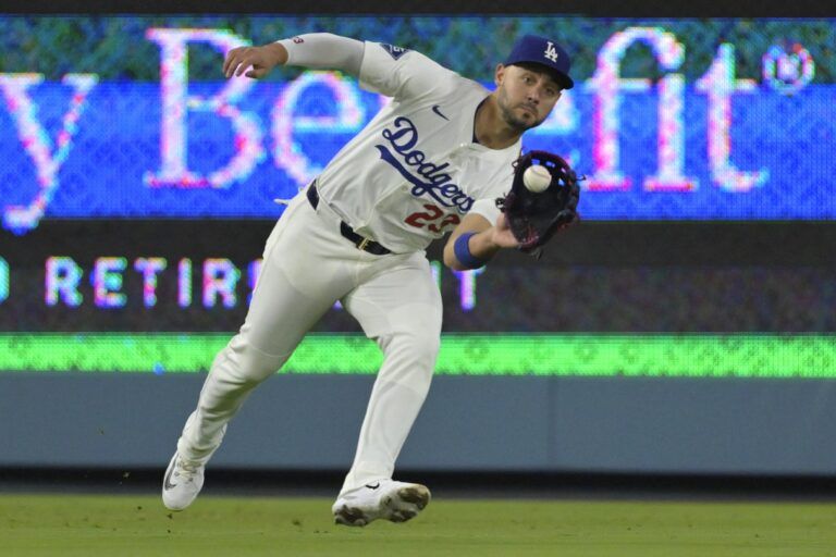 Los Angeles Dodgers left fielder Michael Conforto (23) makes a running catch off New York Mets third baseman Brett Baty (7) in the fifth inning at Dodger Stadium.
