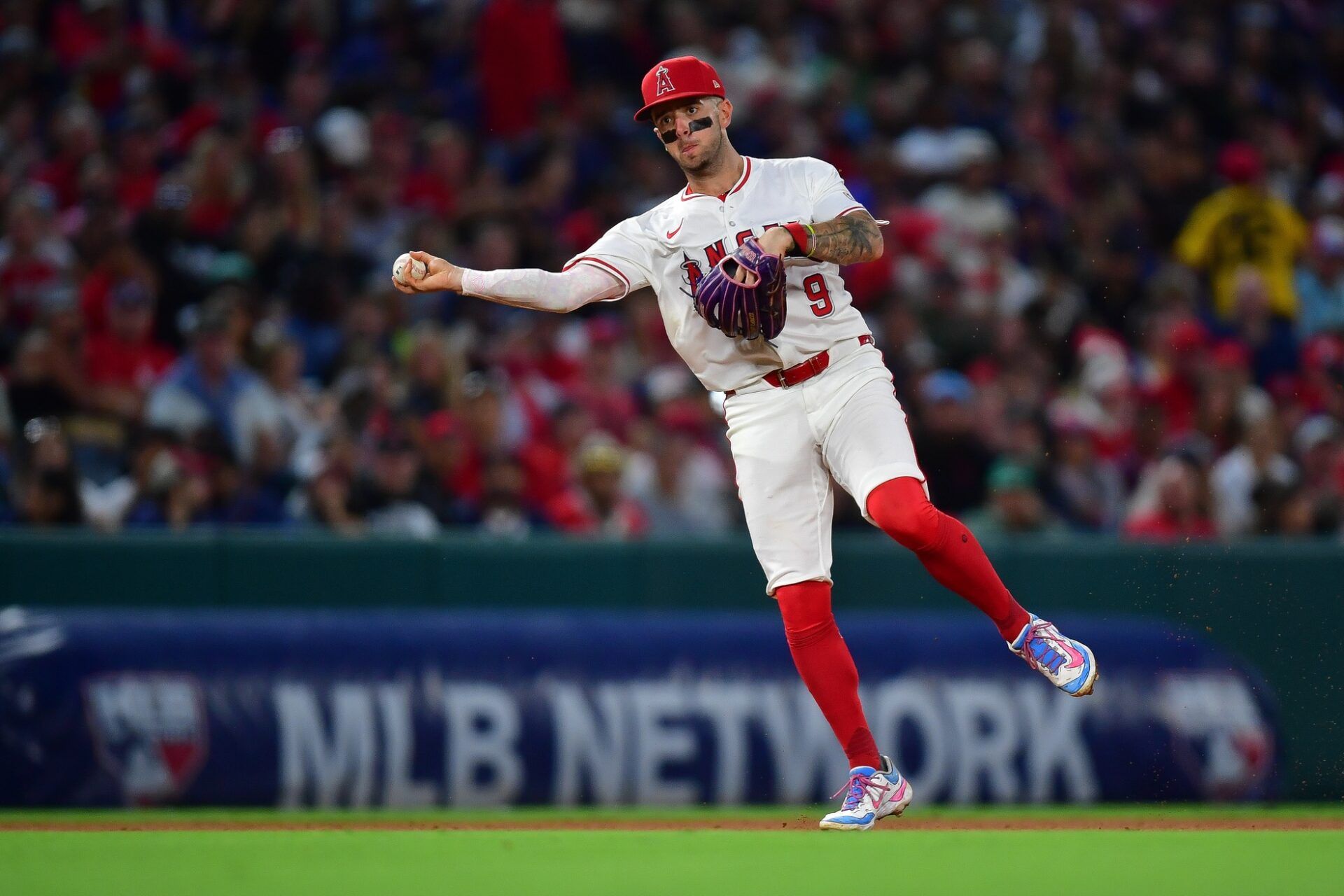 Los Angeles Angels shortstop Zach Neto (9) throws to first for the out against  Boston Red Sox center fielder Ceddanne Rafaela (3) during the seventh inning at Angel Stadium.