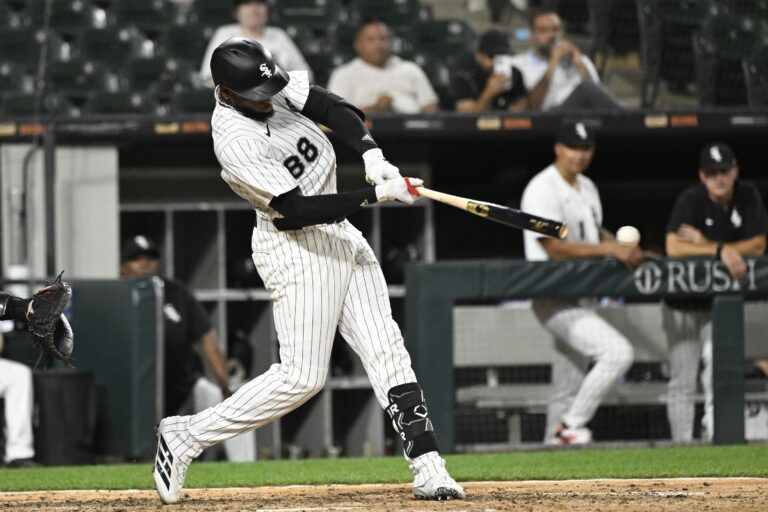 Chicago White Sox outfielder Luis Robert Jr. (88) hits a single during the ninth inning against the Arizona Diamondbacks at Rate Field.