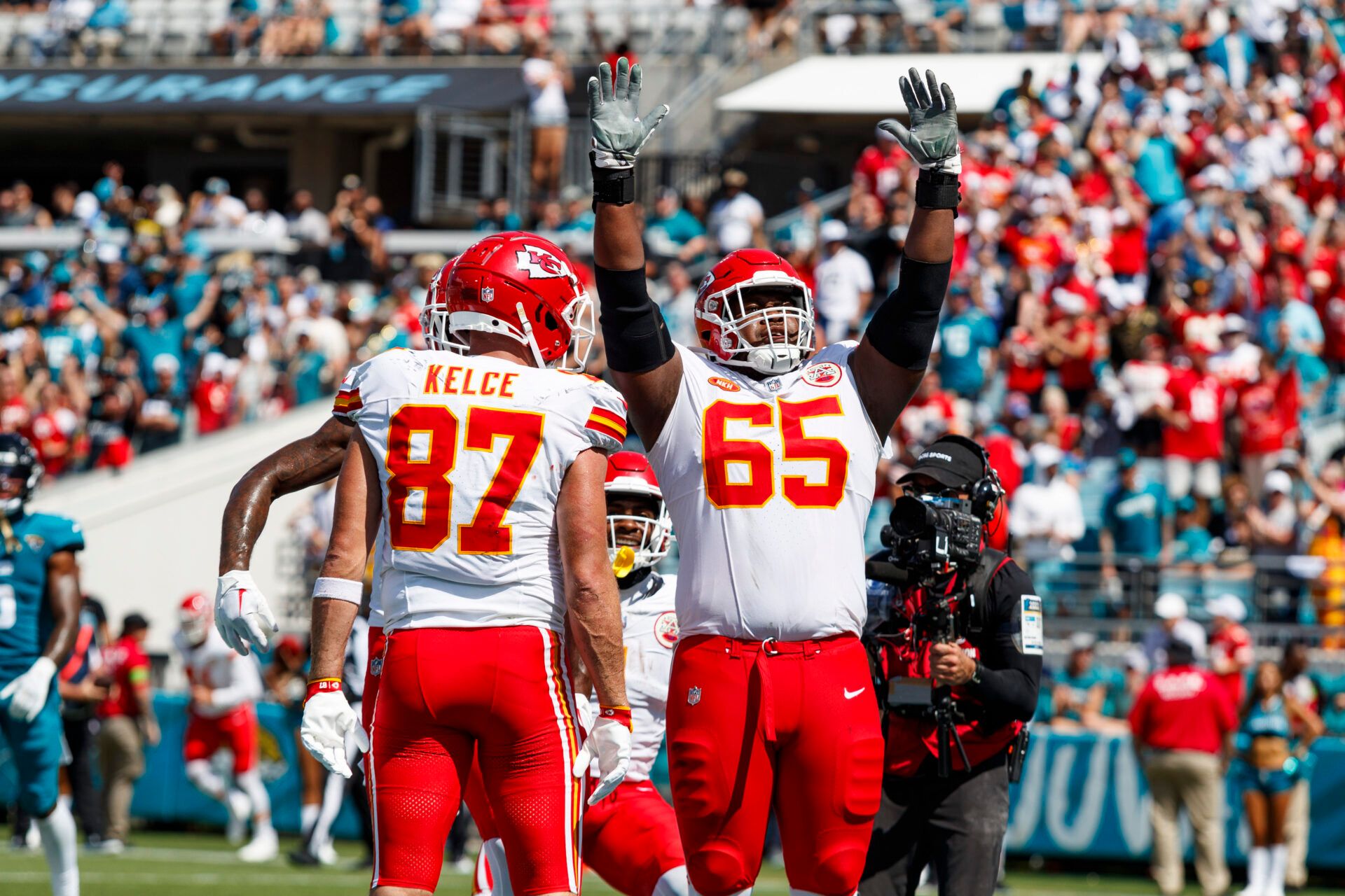 Kansas City Chiefs tight end Travis Kelce (87) celebrates a touchdown with guard Trey Smith (65) against Jacksonville Jaguars during the third quarter at EverBank Stadium.