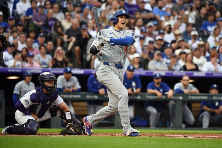 Los Angeles Dodgers two-way player Shohei Ohtani (17) yells as he hits a foul ball during an at bat in the third inning against the Colorado Rockies at Coors Field.