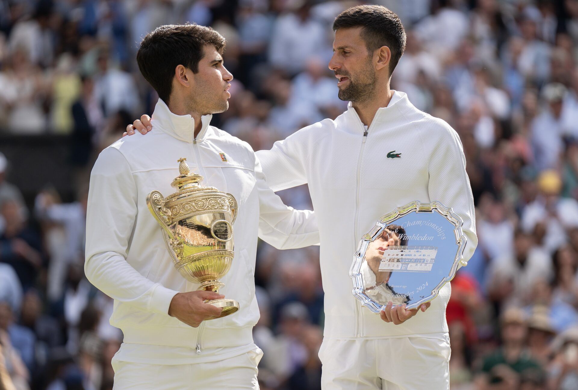Carlos Alcaraz of Spain and Novak Djokovic of Serbia pose with their trophies after the menÕs singles final on day 14 at All England Lawn Tennis and Croquet Club.
