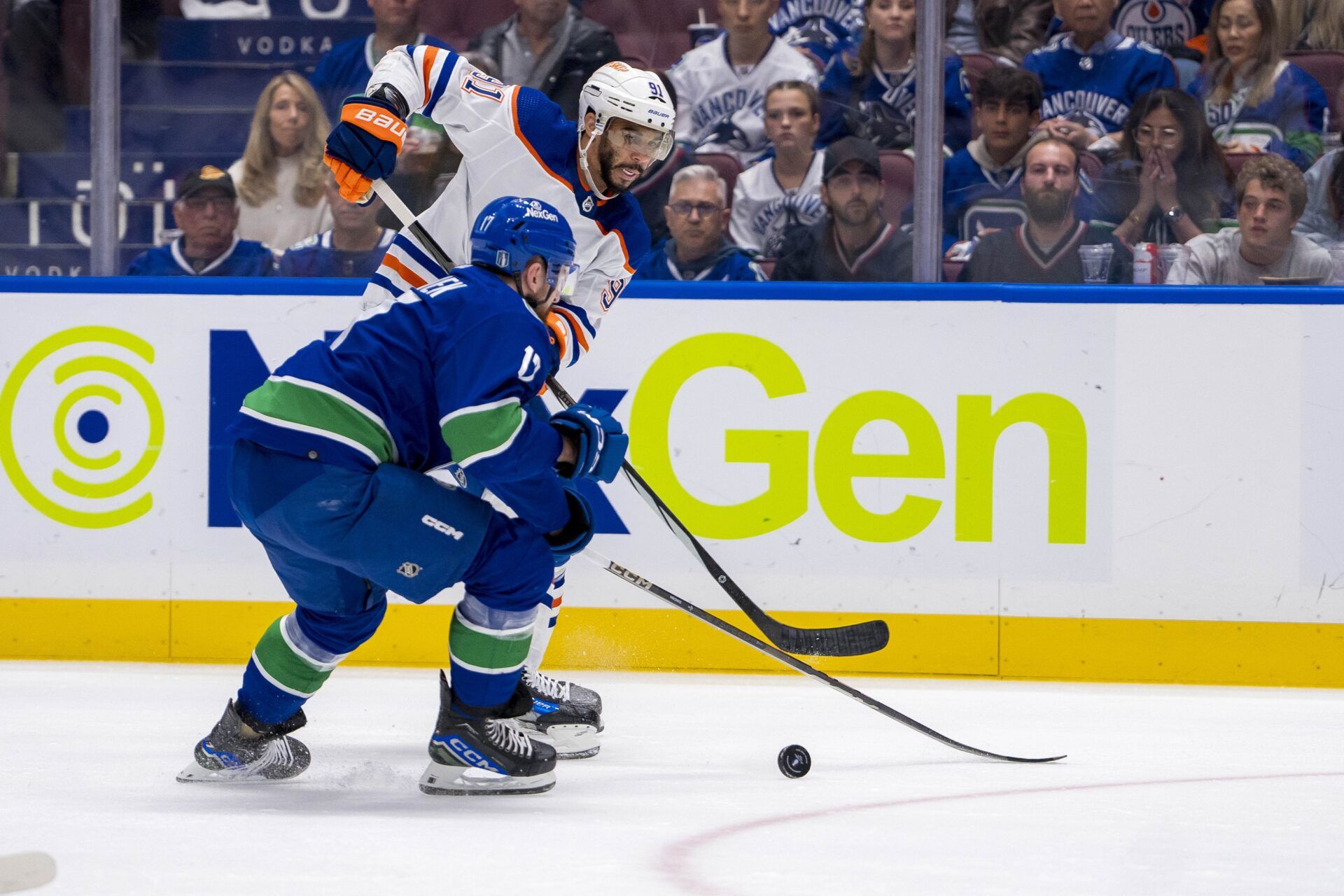 Edmonton Oilers forward Evander Kane (91) passes around Vancouver Canucks defenseman Filip Hronek (17) during the second period in game five of the second round of the 2024 Stanley Cup Playoffs at Rogers Arena.