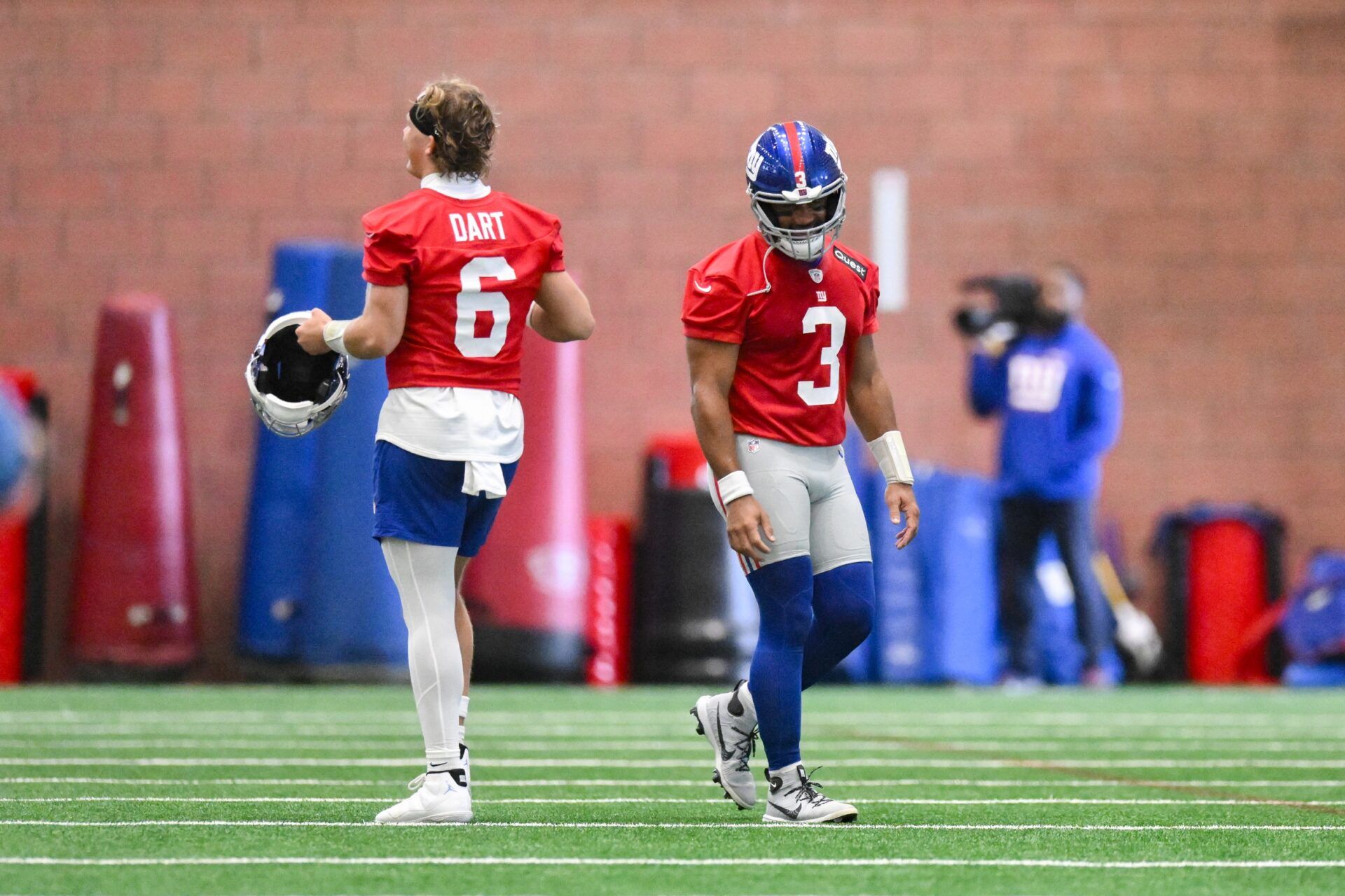 New York Giants quarterback Jaxson Dart (6) and quarterback Russell Wilson (3) interact during minicamp at Quest Diagnostics Training Center.