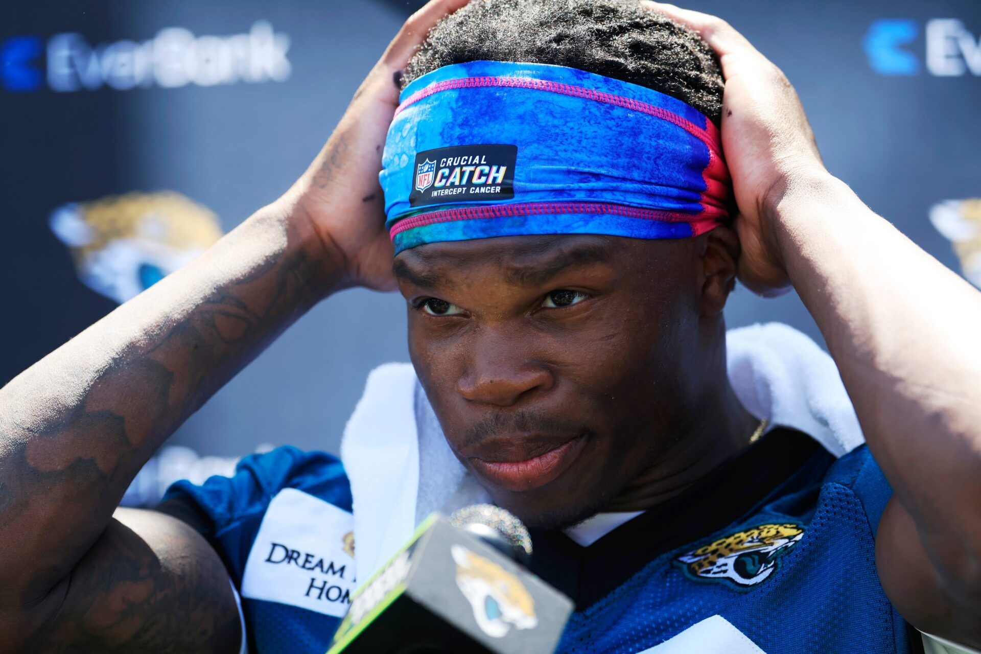 Jacksonville Jaguars wide receiver Travis Hunter (12) adjusts his headband before speaking to members of the media during the second mandatory minicamp at Miller Electric Center Wednesday, June 11, 2025 in Jacksonville, Fla.