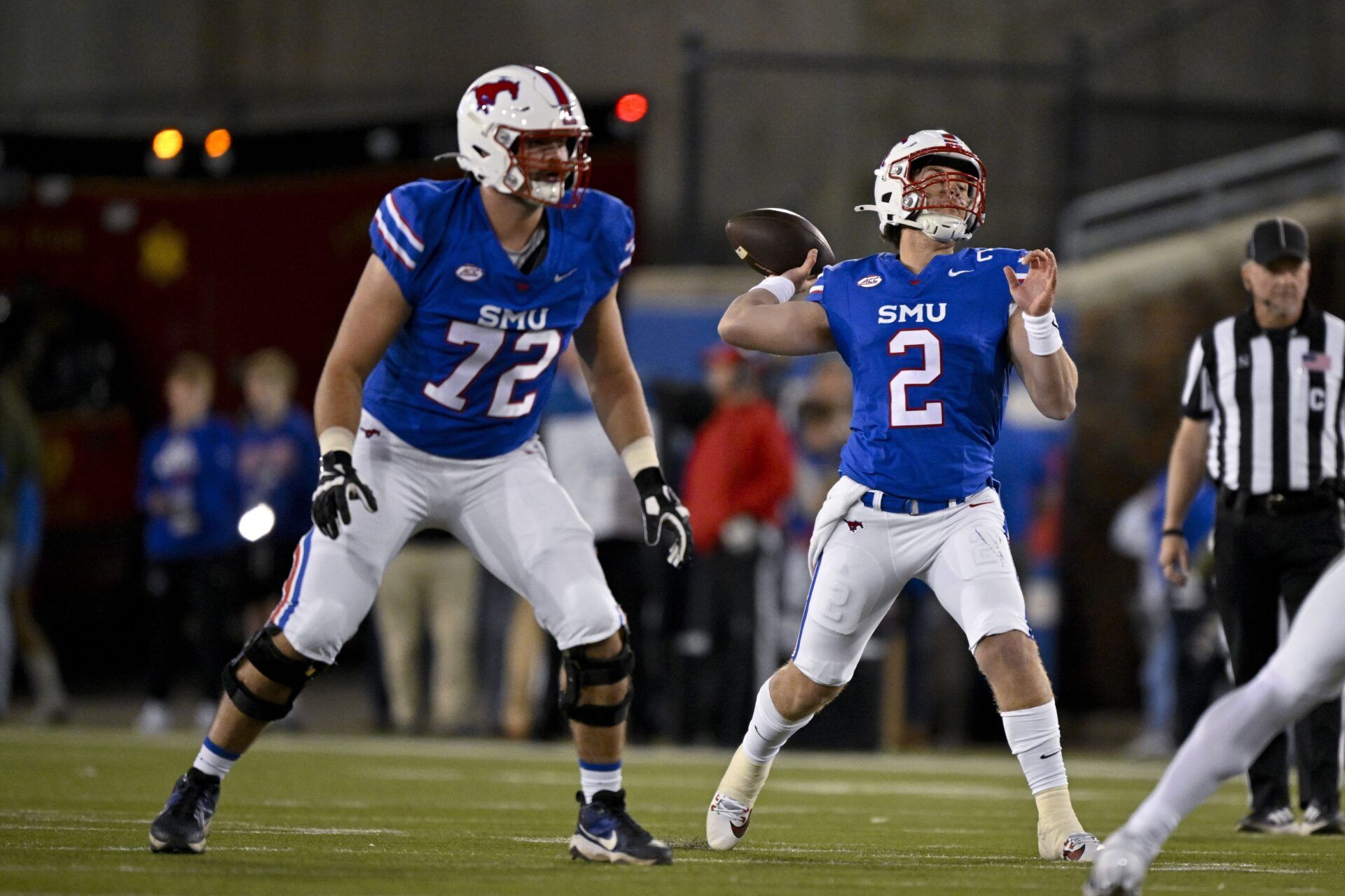 Southern Methodist Mustangs offensive lineman Caleb Johnson (72) and quarterback Preston Stone (2) in action during the game between the SMU Mustangs and the California Golden Bears at Gerald J. Ford Stadium.