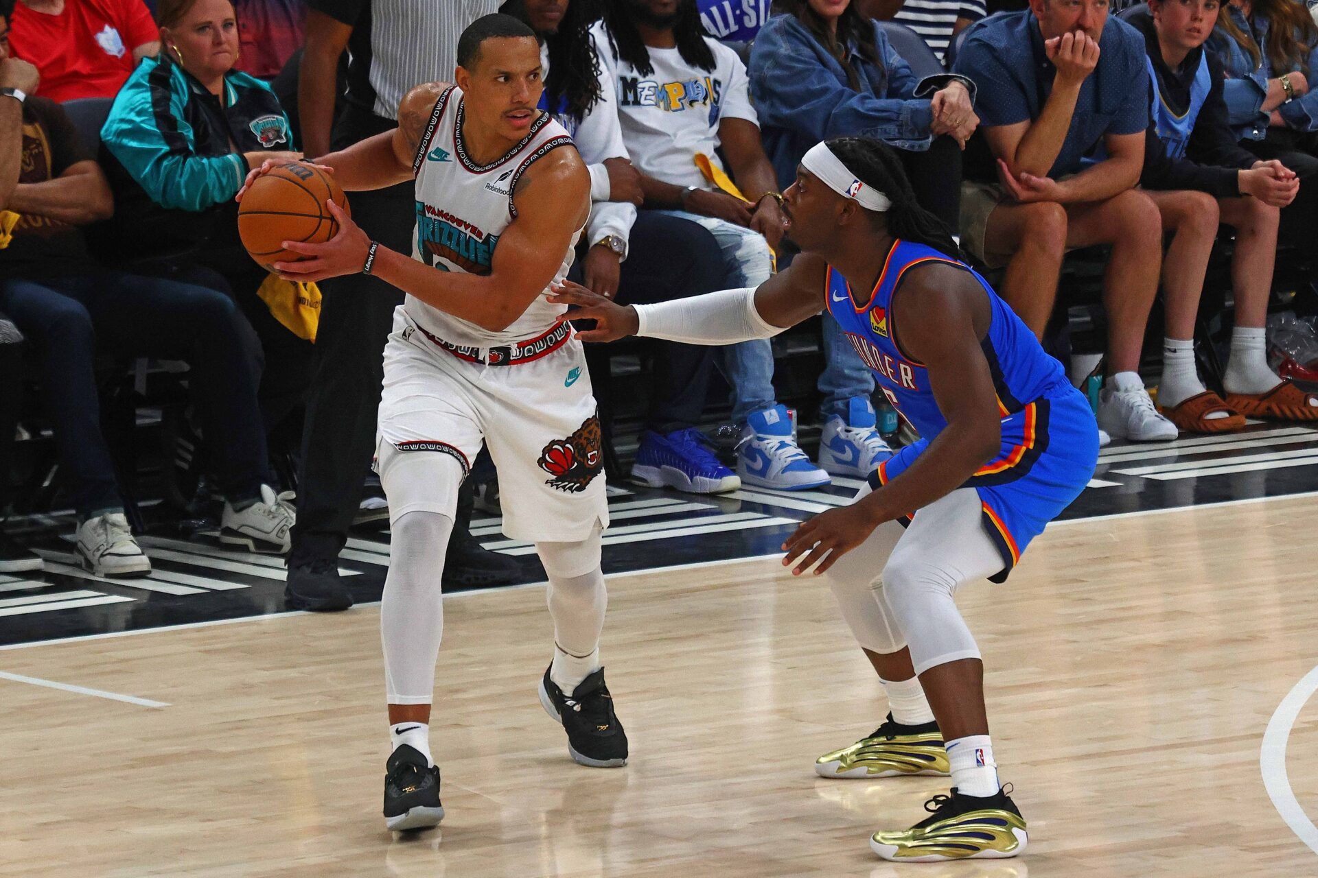 Memphis Grizzlies guard Desmond Bane (22) handles the ball as Oklahoma City Thunder guard Luguentz Dort (5) defends during the third quarter during game three for the first round of the 2025 NBA Playoffs at FedExForum.