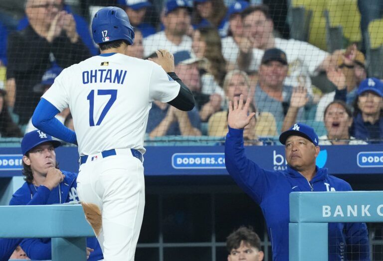 Los Angeles Dodgers manager Dave Roberts (30) celebrates with designated hitter Shohei Ohtani (17) after he scored during the second inning against the Miami Marlins at Dodger Stadium.