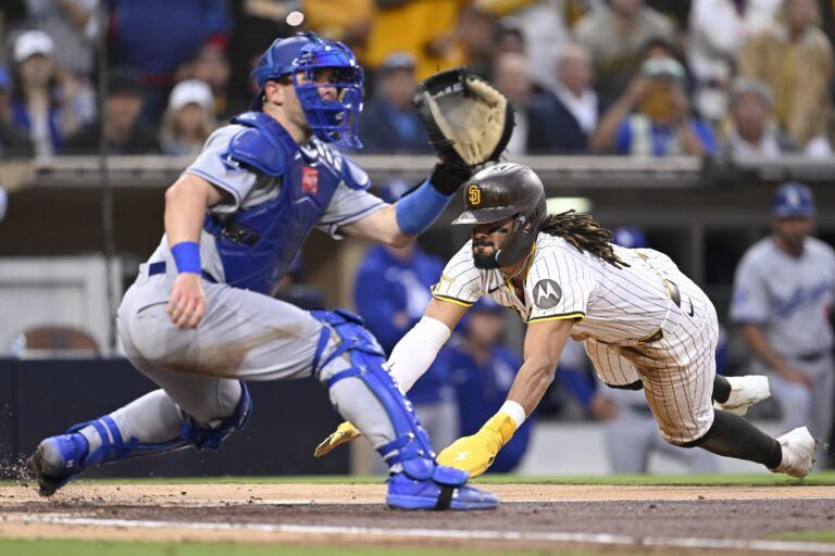 San Diego Padres right fielder Fernando Tatis Jr. (23) scores ahead of the throw to Los Angeles Dodgers catcher Dalton Rushing (68) during the third inning at Petco Park.