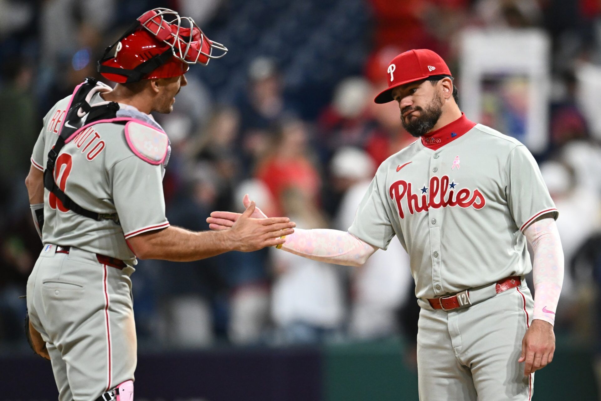 Philadelphia Phillies catcher J.T. Realmuto (10) and designated hitter Kyle Schwarber (12) celebrate after the Phillies beat the Cleveland Guardians at Progressive Field.