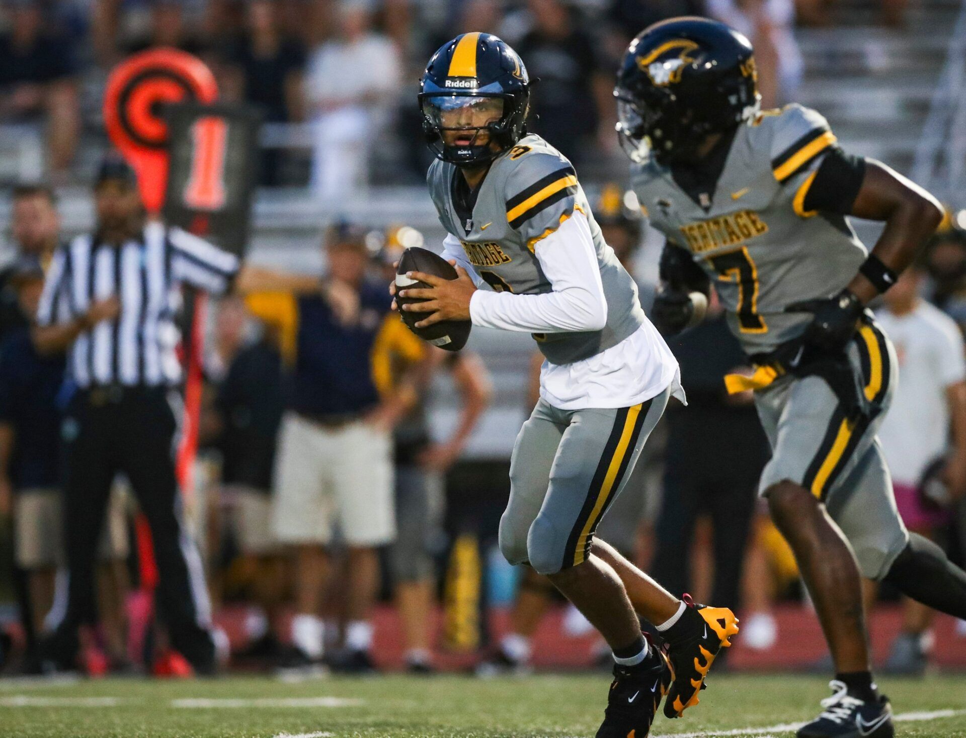 American Heritage Patriots quarterback Dia Bell (3) runs an option play during the first quarter of a game against the Naples Golden Eagles at Staver Field in Naples on Friday, Sept. 13, 2024.