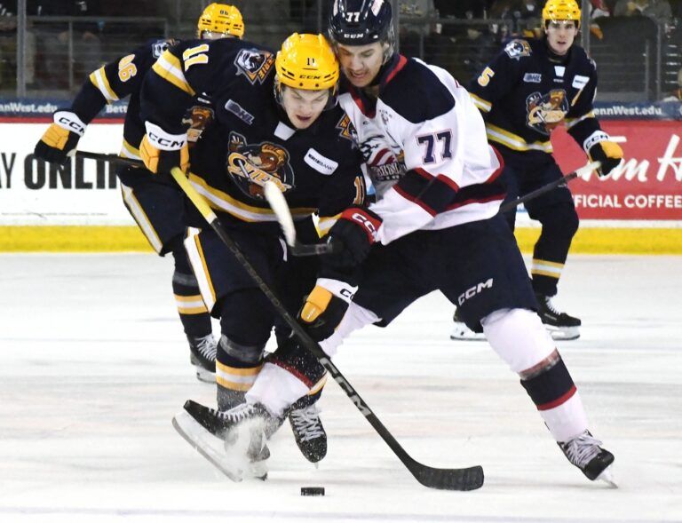 Erie Otters forward Dylan Edwards, leftt, competes against Saginaw Spirit forward Michael Misa during an Ontario Hockey League playoff game at Erie Insurance Arena in Erie on April 1, 2025.