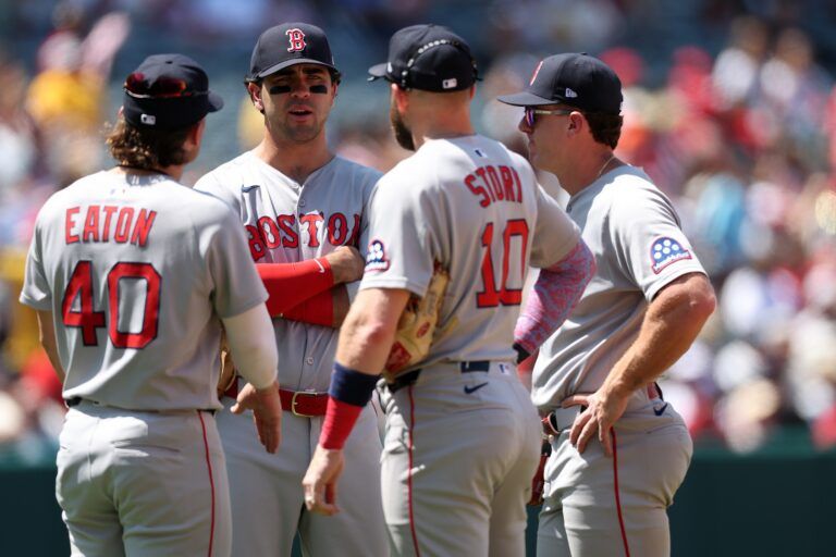 Boston Red Sox infielders (from left) Nate Eaton (40) and Romy Gonzalez (23) and Trevor Story (10) and Marcelo Mayer huddle during a pitching change in the fifth inning against the Los Angeles Angels at Angel Stadium.