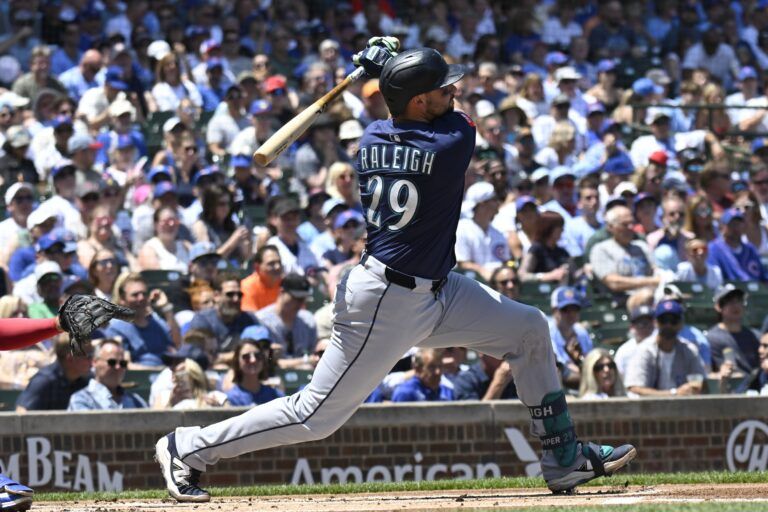 Seattle Mariners catcher Cal Raleigh (29) hits a home run against the Chicago Cubs during the first inning at Wrigley Field.