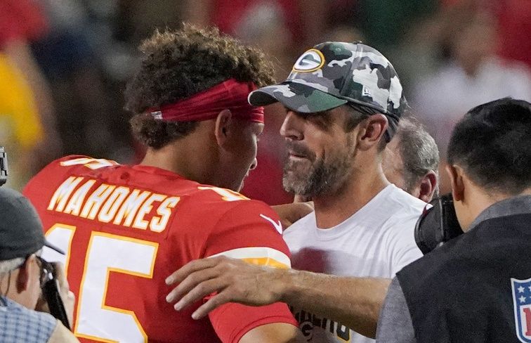 Kansas City Chiefs quarterback Patrick Mahomes (15) and Green Bay Packers quarterback Aaron Rodgers (12) embrace after a game at GEHA Field at Arrowhead Stadium.