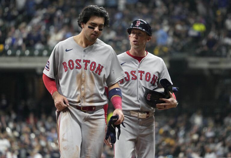 Boston Red Sox third base coach/outfield instructor Kyle Hudson (84) talks with Boston Red Sox shortstop Marcelo Mayer (39) after the top of the seventh inning against the Milwaukee Brewers  at American Family Field.