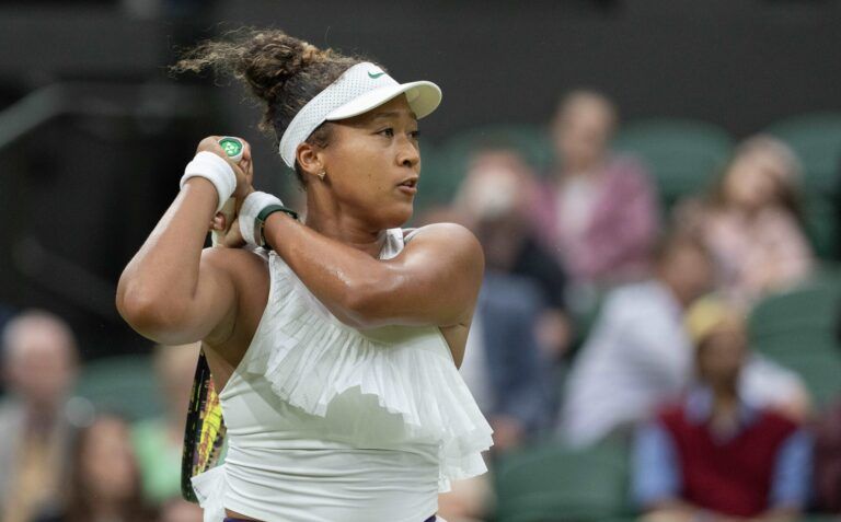 Naomi Osaka of Japan follows through on a shot during her match against Emma Navarro of the United States (not shown) on day three of The Championships at All England Lawn Tennis and Croquet Club.