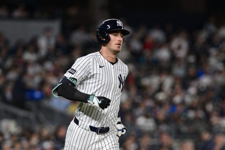 New York Yankees outfielder Cody Bellinger (35) hits a single against the Boston Red Sox during the sixth inning at Yankee Stadium.