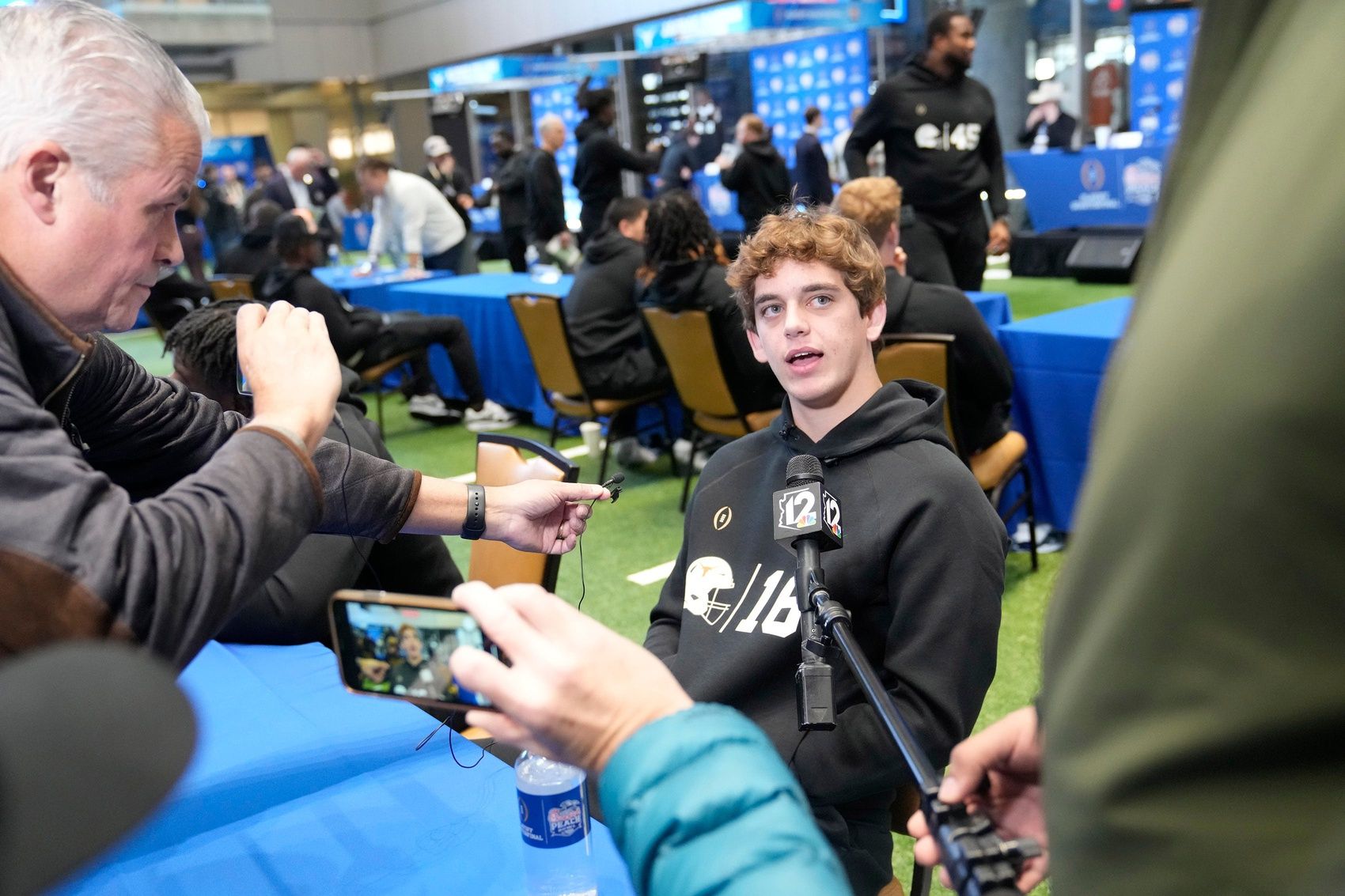 Texas quarterback Arch Manning answers questions during media day for the Chick-fil-A Peach Bowl in Atlanta on Monday, Dec. 30, 2024.