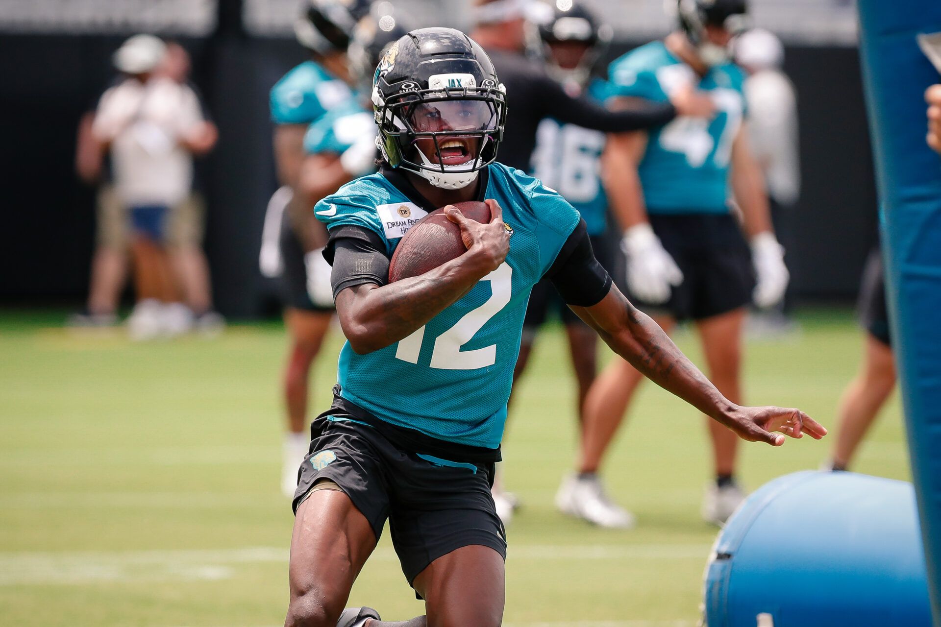 Jacksonville Jaguars wide receiver Travis Hunter (12) runs after completing a passing drill during rookie minicamp at Miller Electric Center.