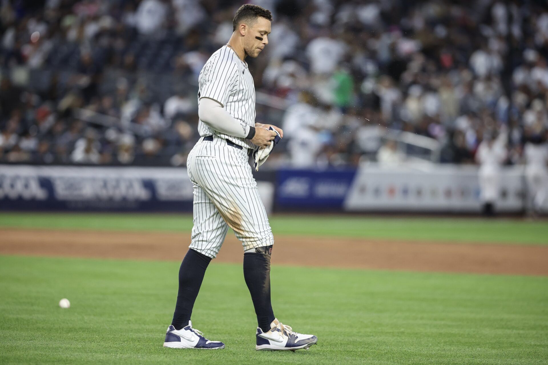 New York Yankees right fielder Aaron Judge (99) walks back to the field after striking out with the bases loaded to end the fourth inning against the Athletics at Yankee Stadium.