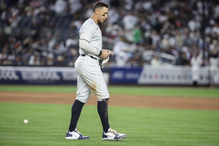 New York Yankees right fielder Aaron Judge (99) walks back to the field after striking out with the bases loaded to end the fourth inning against the Athletics at Yankee Stadium.