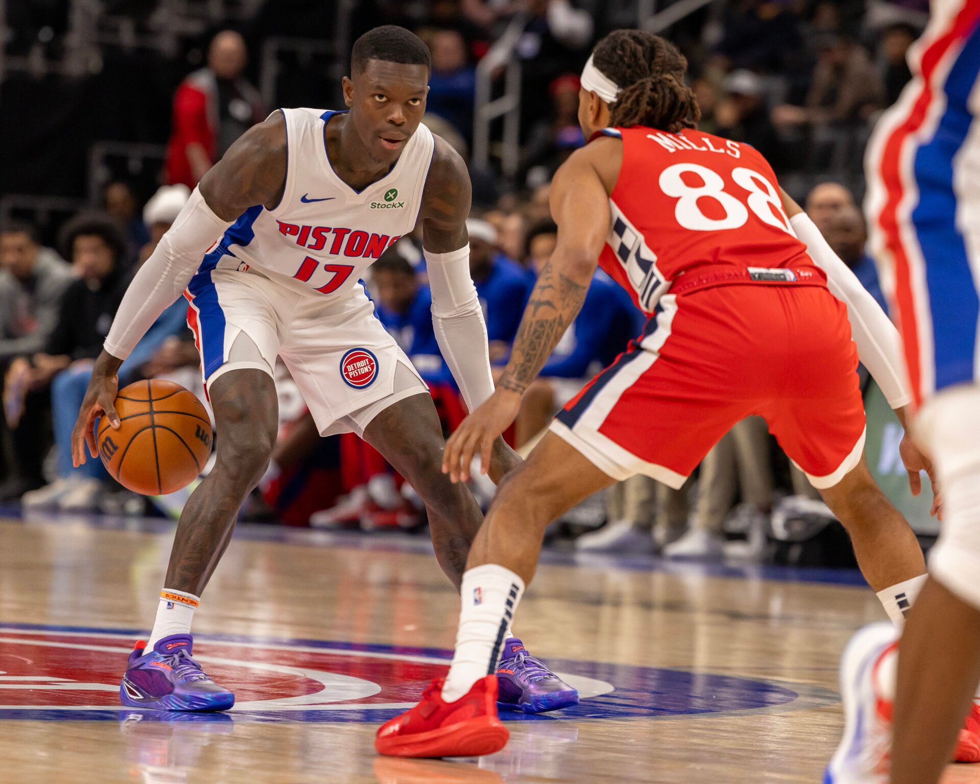 LA Clippers guard Patty Mills (88) defends against Detroit Pistons guard Dennis Schröder (17) during the first half at Little Caesars Arena.