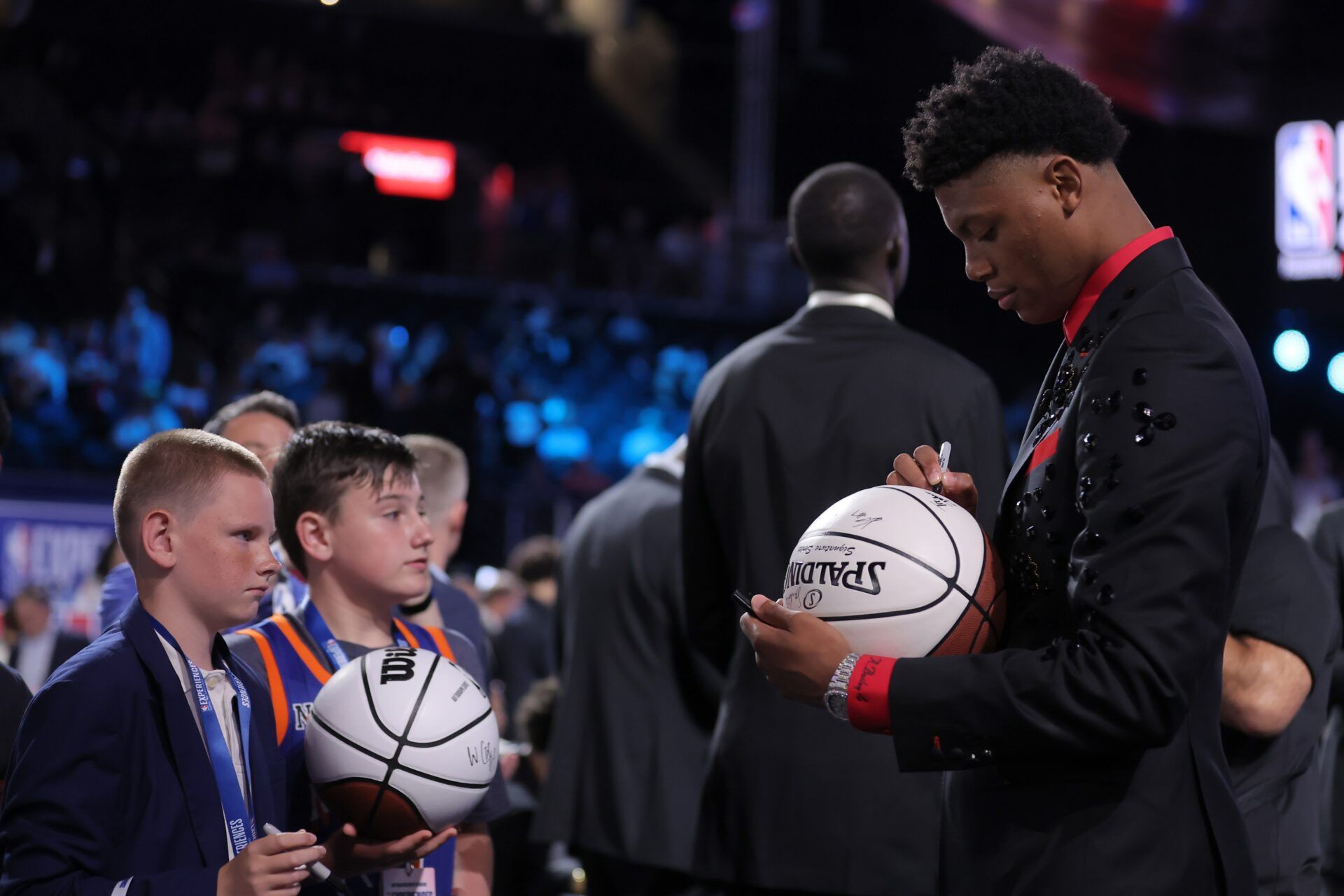 Ace Bailey signs autographs before the 2025 NBA Draft at Barclays Center.